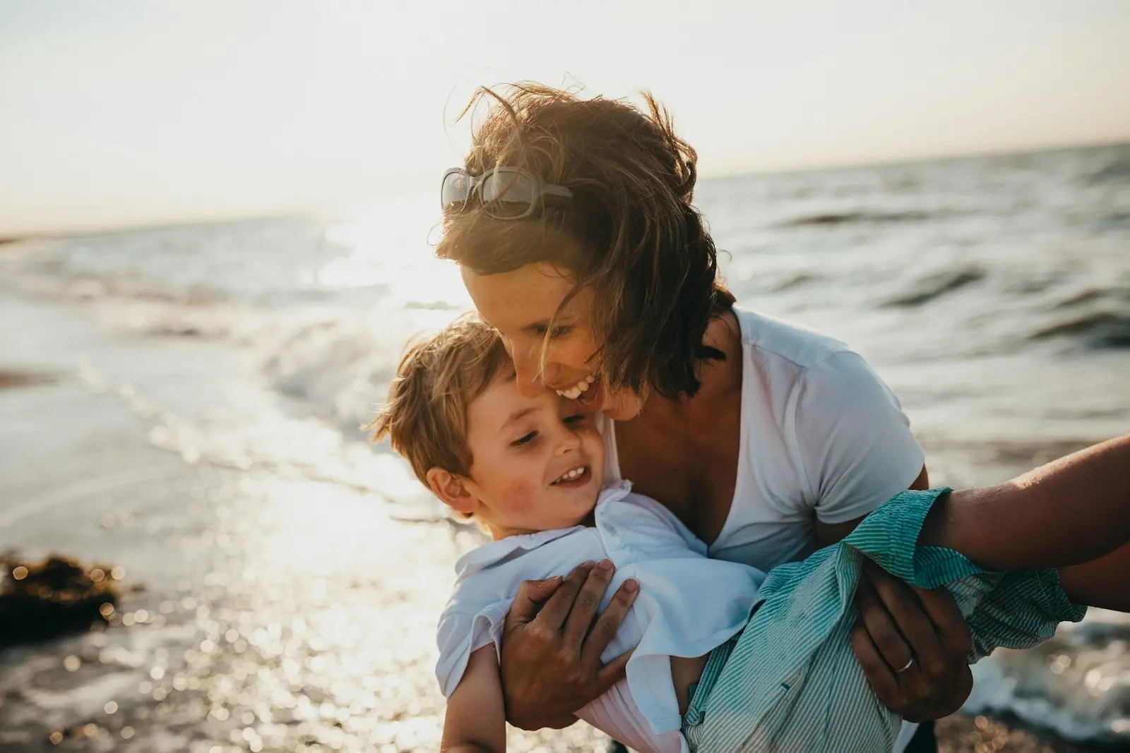 Mother and son enjoying a sunny day at the beach